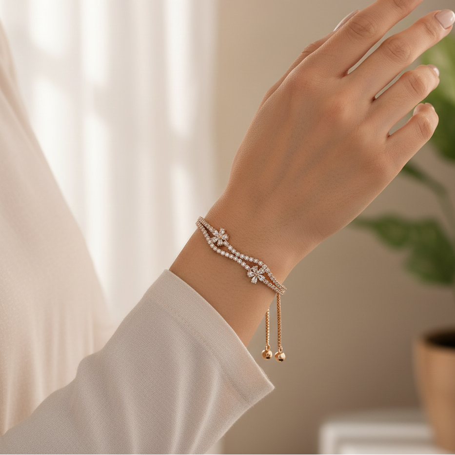 Hand wearing a delicate bracelet with a soft background